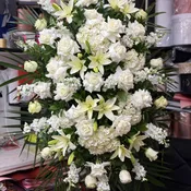 Peace & Prayers White Standing Spray.   The photo shows a deluxe size.