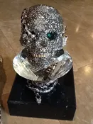 CRYSTAL AND EMERALD SKULL WITH MARBLE BASE