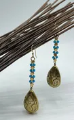 Teardrop earrings with turquoise colored beads and gold electroplated metal