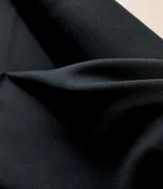 Backed wool gabardine in black - $34/yd