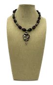 Polished, spiral cut black onyx necklace with zebra print wood pendant