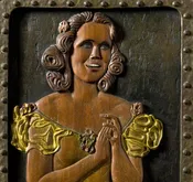 Carved Relief of a Singing Woman in Yellow dress