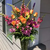 Roses, lilies, carnations, and other seasonal flowers.