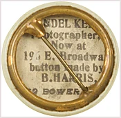 7/8” real photo button without dot pattern pictures both men in sepia with their names above.