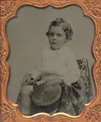 BOY HOLDING HAT.