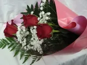 3 RED ROSES WRAPPED IN NICE PAPER WITH (R)
