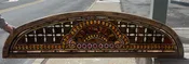 Amazing arched antique stained glass window loaded with jewels and roundels.