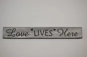 12″ Hand crafted sign that reads “Love lives here” Engraved Hearts
