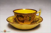 An Antique English Creamware yellow glazed tea cup and saucer with lustre decoration, c1820