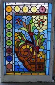 American Aesthetic Movement stained glass window with roundels and jewels.