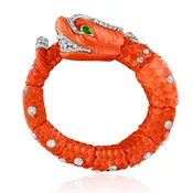CARVED CORAL, EMERALD, AND DIAMOND CHIMERA BANGLE BY CARTIER, PARIS, CIRCA 1960