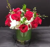 12 red diamonds in a vase.