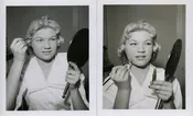 DOING HER MAKEUP.