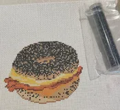 BACON EGG AND CHEESE ON A POPPY SEED BAGEL W/ BEADS