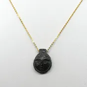 A Coptic Basalt Face Pendant, Coptic Period, ca. 3rd - 7th century CE