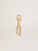 Charm aus goldfarbenem Messing in Form des Buchstabens Q mit Glassteinchen