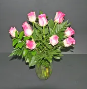 A DOZEN PINK ROSES IN CLEAR VASE