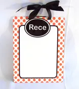 Personalized dry erase board with orange polka dot pattern and black trim
