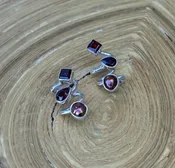 E92 Garnet & Copper Pearl Earrings — Lilly Barrack  Seasoned artist, Lilly Barrack, has been designing hand-made sterling silver gemstone jewelry for more than three decades. The Lilly Barrack’s three store locations (two in Albuquerque, NM, and one in Scottsdale, AZ.) carry exclusive gift items and designs from upwards of 60 unique artists.