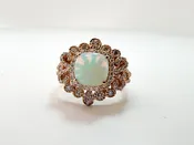 14k, Rose gold, 1.40 carat Ethiopian opal set with .60 carats of side diamonds.