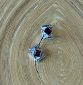 E34 Garnet Earrings — Lilly Barrack  Seasoned artist, Lilly Barrack, has been designing hand-made sterling silver gemstone jewelry for more than three decades. The Lilly Barrack’s three store locations (two in Albuquerque, NM, and one in Scottsdale, AZ.) carry exclusive gift items and designs from upwards of 60 unique artists.