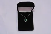 14KT White Gold Oval Emerald Pendant with Diamond Halo