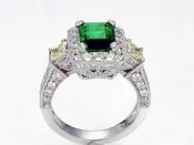 ANTIQUE EMERALD AND FANCYYELLOW DIAMOND THREE STONE RING IN 18 KARAT WHITE GOLD