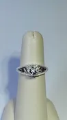 0.95ct clear star brilliant cut Texas topaz is set in a sterling silver filigree ring with hearts.