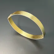 Non Traditional Bangle Bracelet Made in an Almond Shape of 22 Karat Gold and Sterling Silver