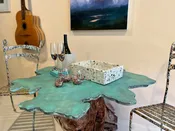 Driftwood Accent Table and Chairs Set – Aqua Marine Stained Concrete Top with Driftwood Base and Splatter Paint Metal Framed Chairs