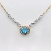 Blue Topaz surrounded with a dimond halo, 6 bezel diamonds.  MeiraT
