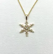 Allison Kaufman: Yellow 14 Karat Gold Snowflake Pendant — McGough & Company