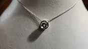 0.50ct clear star brilliant cut Texas topaz is prong set in a sterling silver slide pendant and chain.