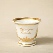A 19th c. Empire style white porcelain chocolate cup with gilt decoration & "Offert par l'Amitie" script c. 1880