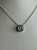 0.90ct clear star brilliant cut Texas topaz is backset in a sterling silver slide pendant and chain.