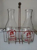 2 Milk jugs with holder 12" tall