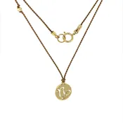 14 Karat Gold Capricorn Zodiac Charm On Light Brown Silk
