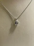 0.95ct clear star brilliant cut Texas topaz is set in a sterling scroll silver pendant with chain.